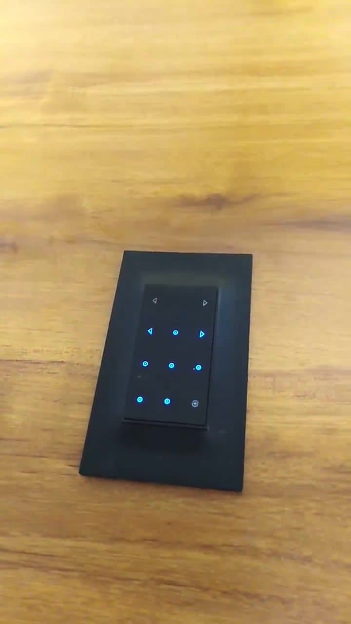 Black touch-sensor switch panel with illuminated blue controls installed by VRC Electrical