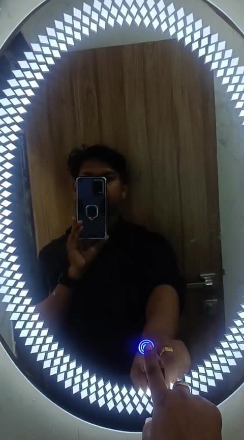 Vivek Chauhan checking a freshly installed LED touch-sensor mirror on site